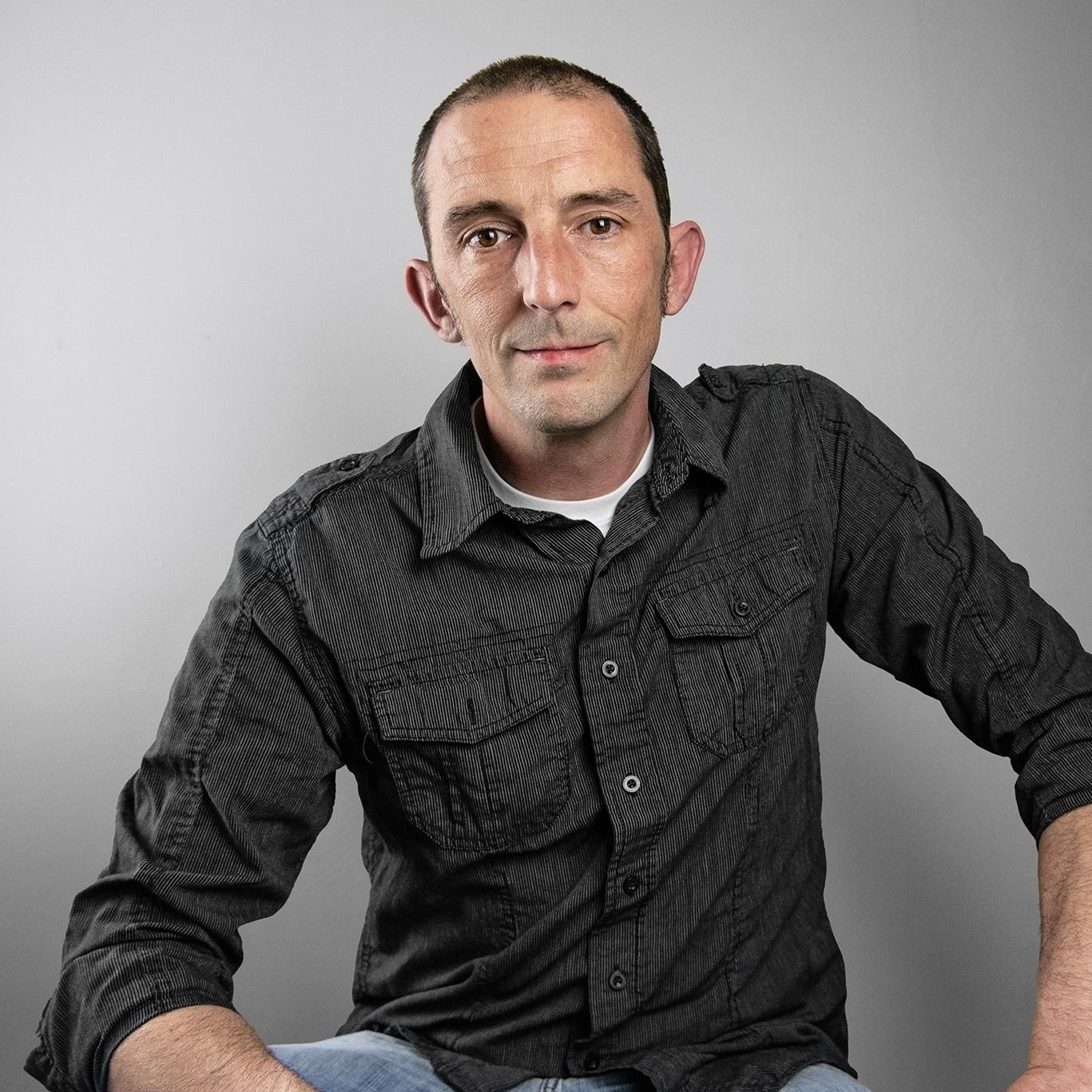 Studio portrait sequence showing casual poses in dark jacket against grey background.