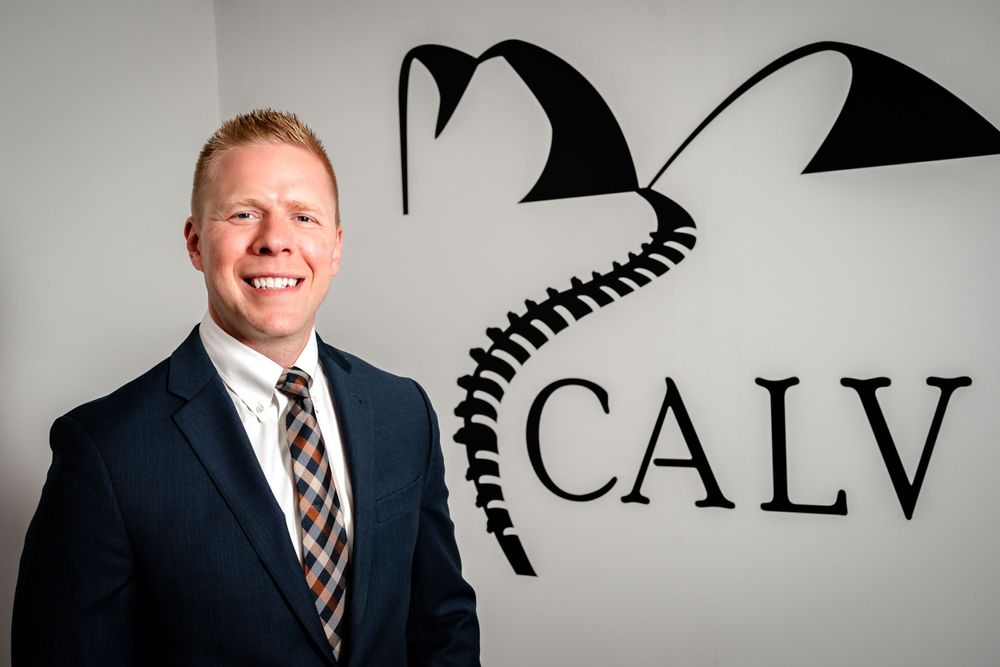 Professional headshots of business team members against a light background with CALV branding.