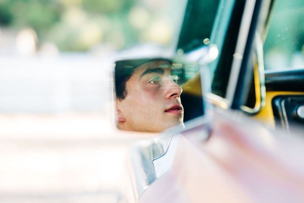 Shoot of a trucks side mirror with a senior boy looking in it, Casmalia, CA