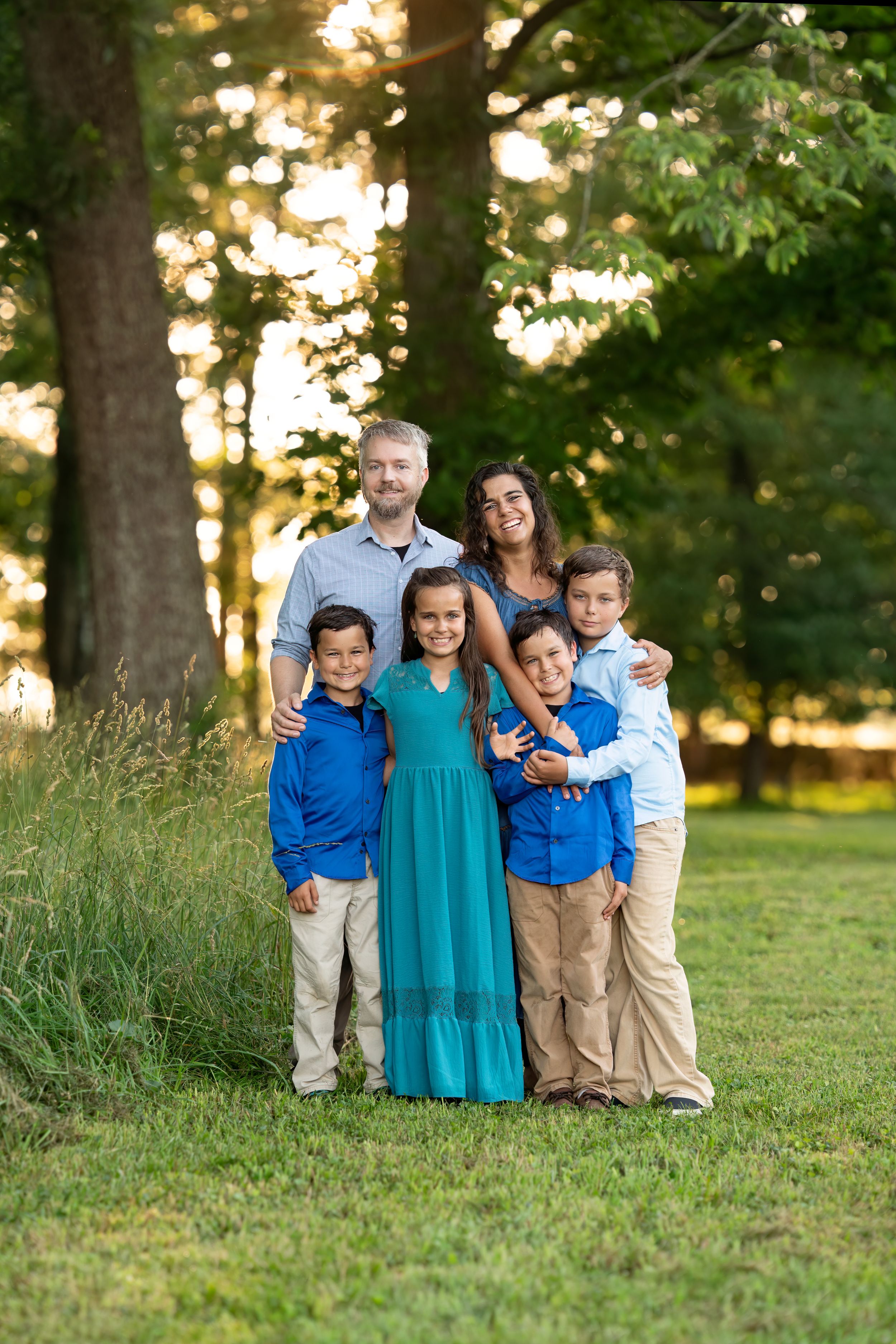 A beautiful family poses together outdoors at Blandy