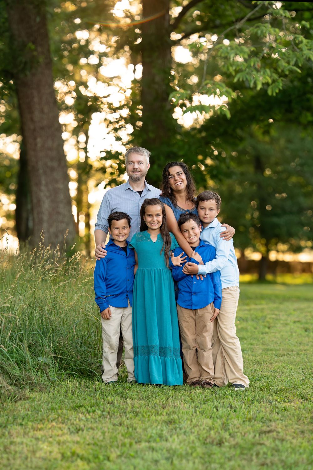 A beautiful family poses together outdoors at Blandy