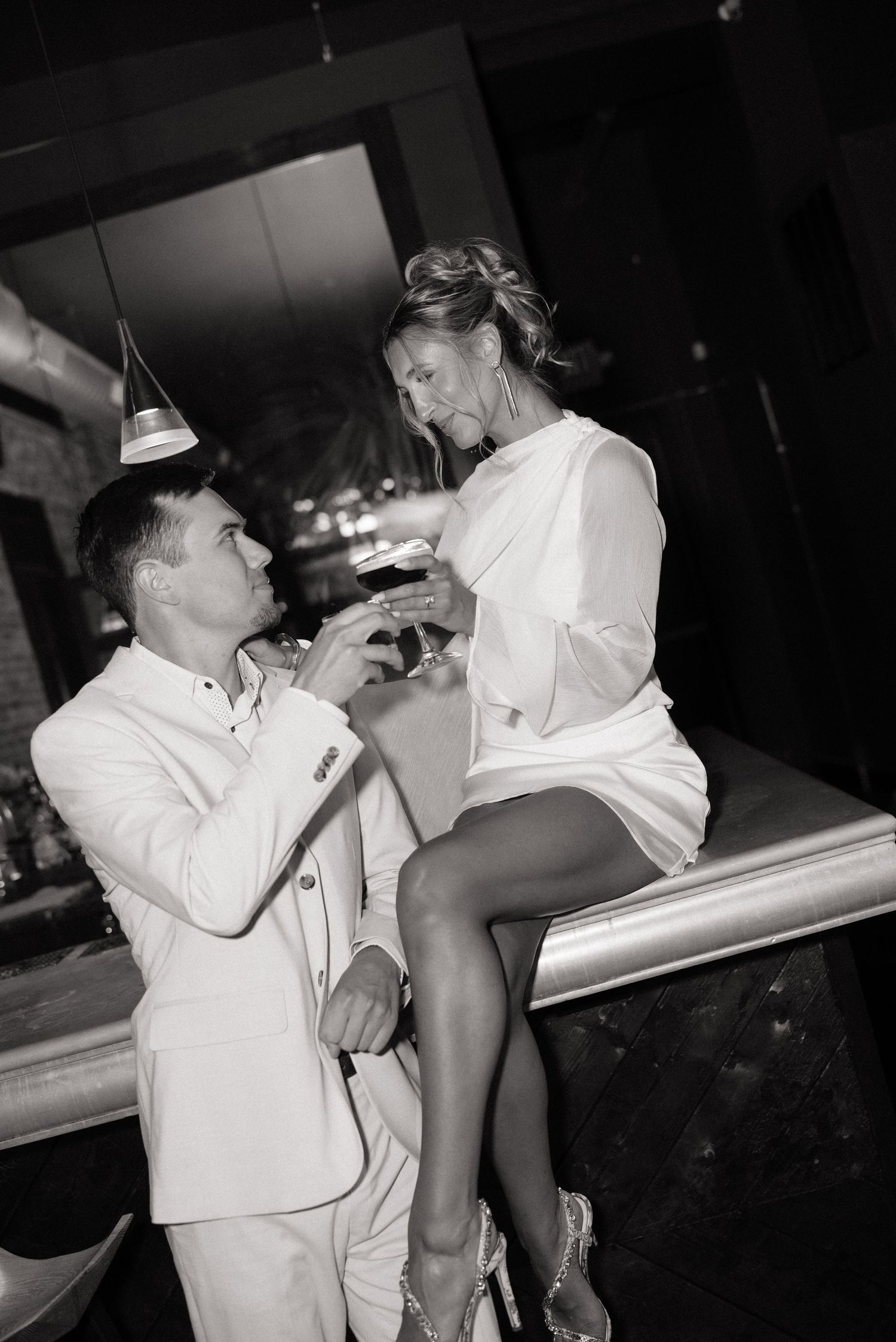 A romantic black and white sequence shows a couple dancing and dipping on a concrete surface.