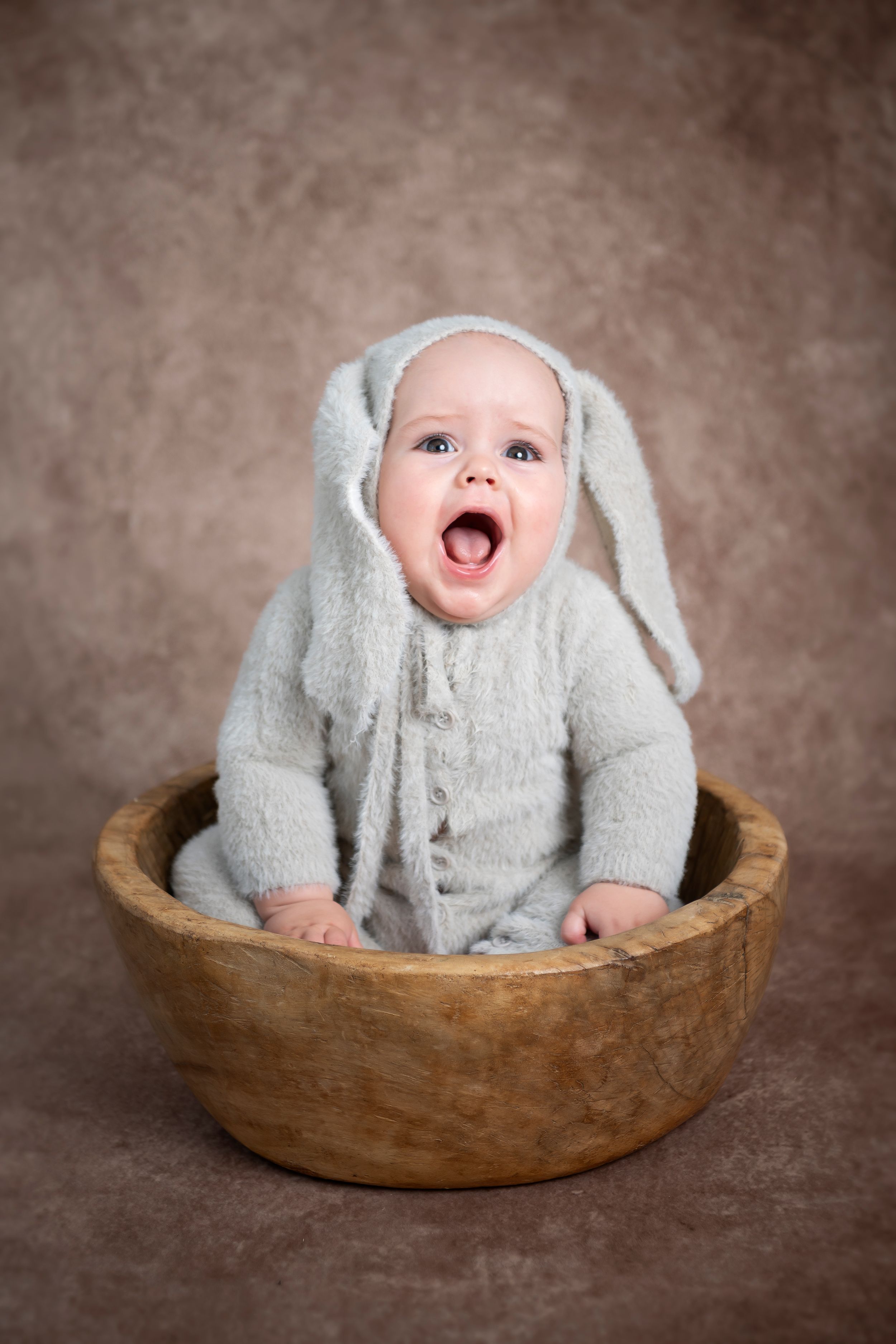 little sitter studio photo based in ashford kent child dressed as a bunny sitting in a wooden bowl