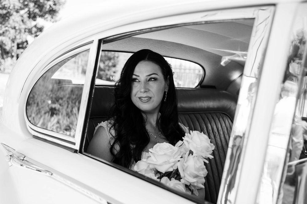 Black and white photo series showing a classic car with passengers smiling through the windows.