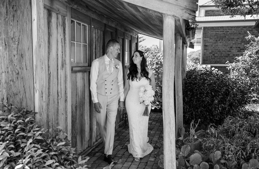A black and white panoramic collage of vintage wedding photos showing couples and guests at an outdoor ceremony.