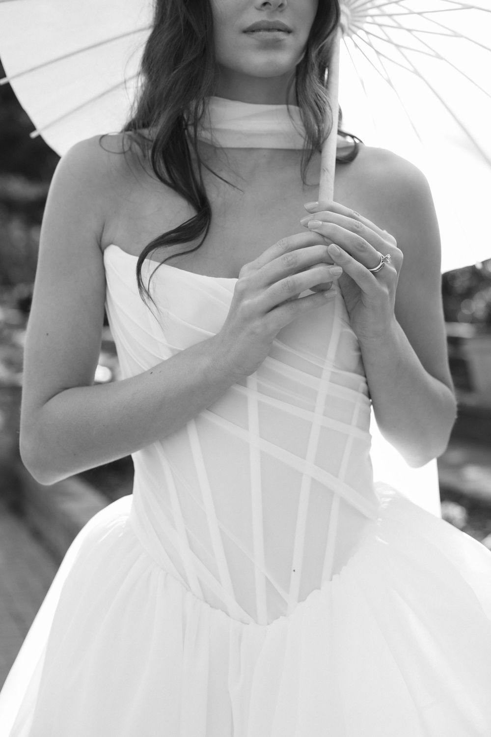Close-up detail of a structured white wedding gown bodice with geometric patterns.