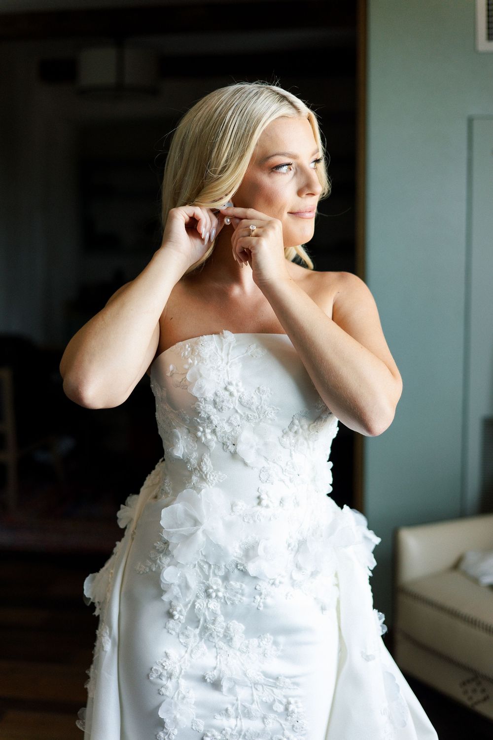 Detail shots of a textured white wedding dress with floral appliques.