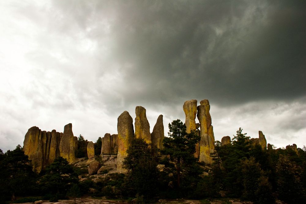 Valle de los Monjes, La Sierra Tarahumara, Chihuahua, México.Ancient rock formations rise against dark storm clouds in a dramatic landscape.