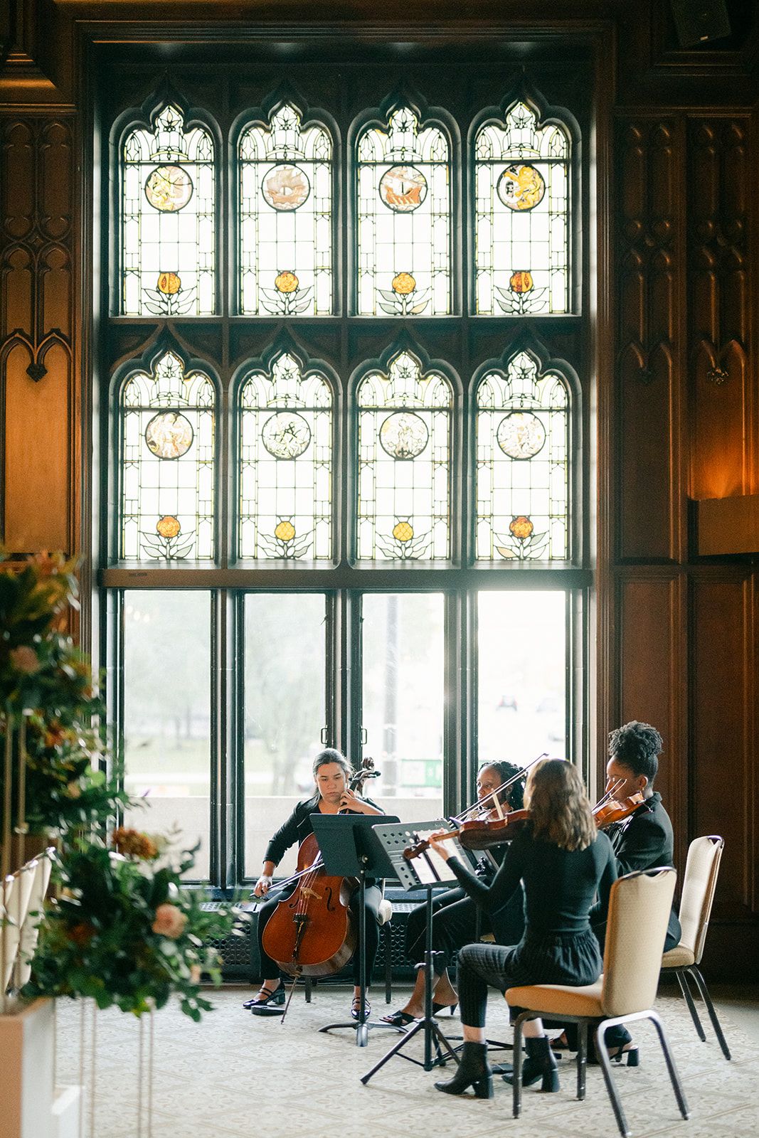 String quartet performing beneath ornate stained glass windows. - University Club of Chicago Wedding Ceremony