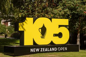 New Zealand Open 105th anniversary yellow and black commemorative sign outdoors.