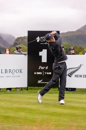 Golfer teeing off at hole 1 par 4 at the New Zealand Open tournament.