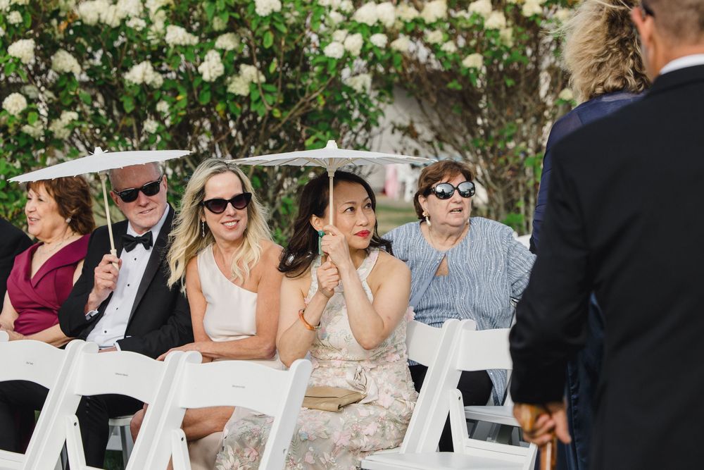 Guests smile Waterfront wedding ceremony at OceanCliff Hotel in Newport, Rhode Island. Wedding photographer in Newport RI