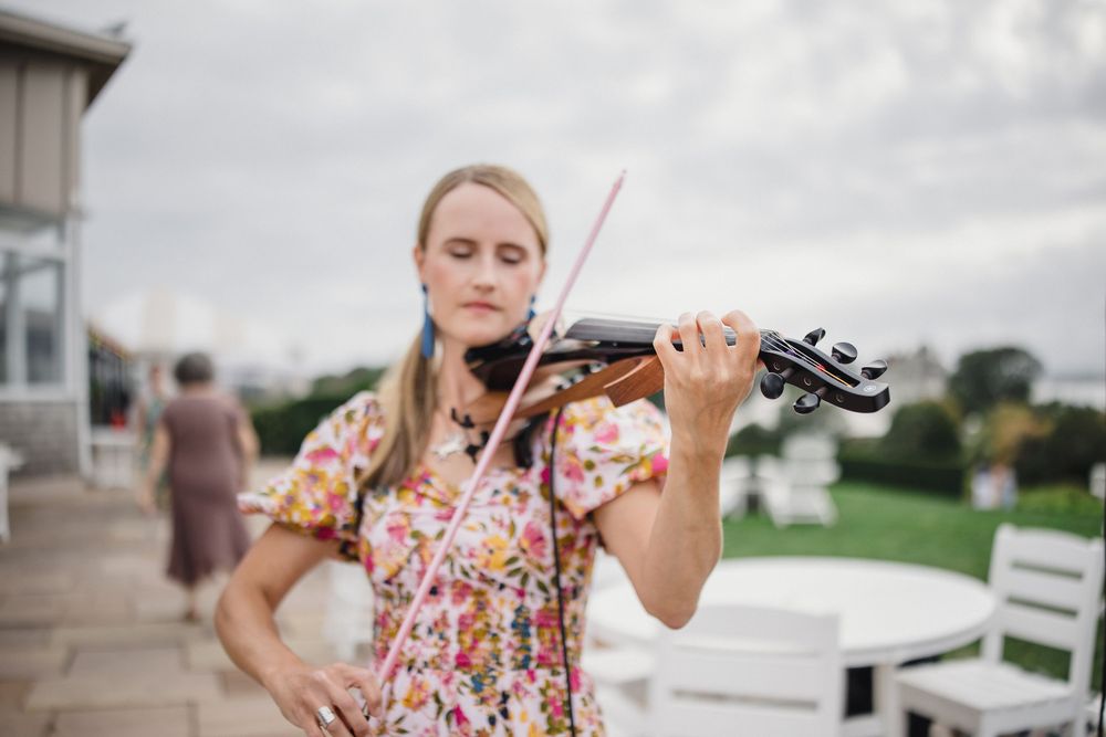 Violinist at Waterfront wedding ceremony at OceanCliff Hotel in Newport, Rhode Island. Wedding photographer in Newport RI