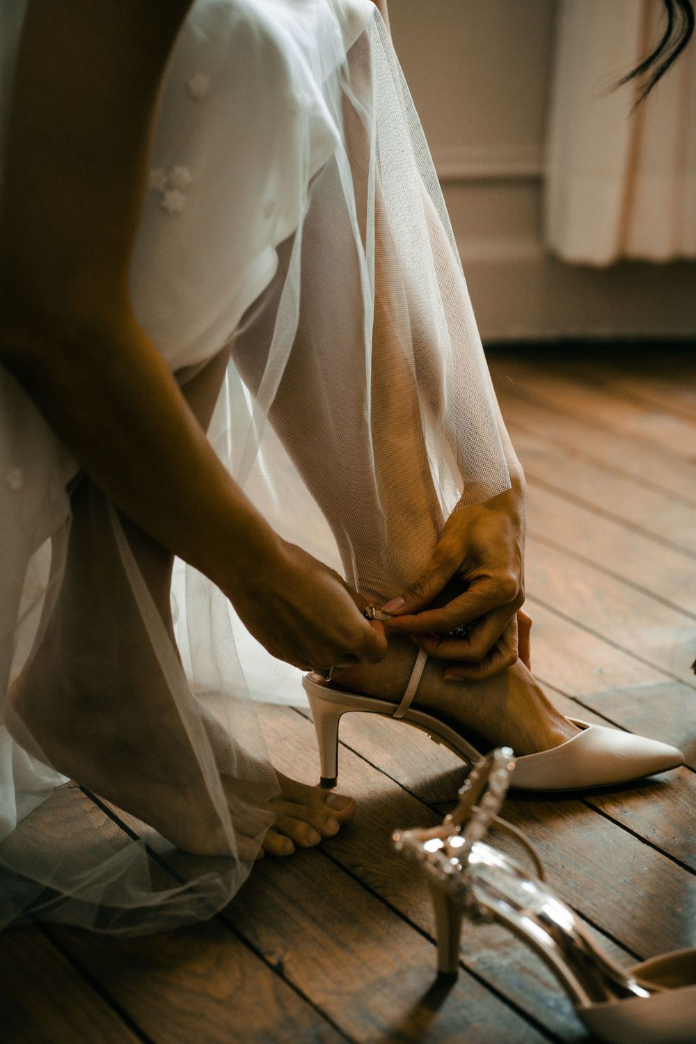 Modern couple in minimalist wedding attire walking through urban architecture, editorial style by 4Steps Agency.