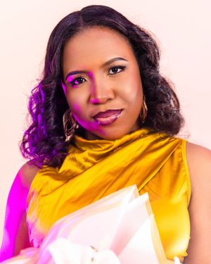 A woman in a gold and white outfit with a yellow scarf poses confidently against a light background.