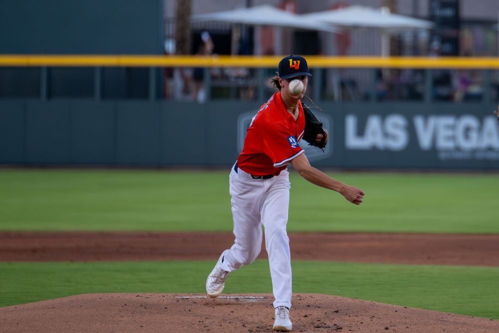 Las Vegas baseball pitcher in red uniform mid-throw on the mound during a professional game.