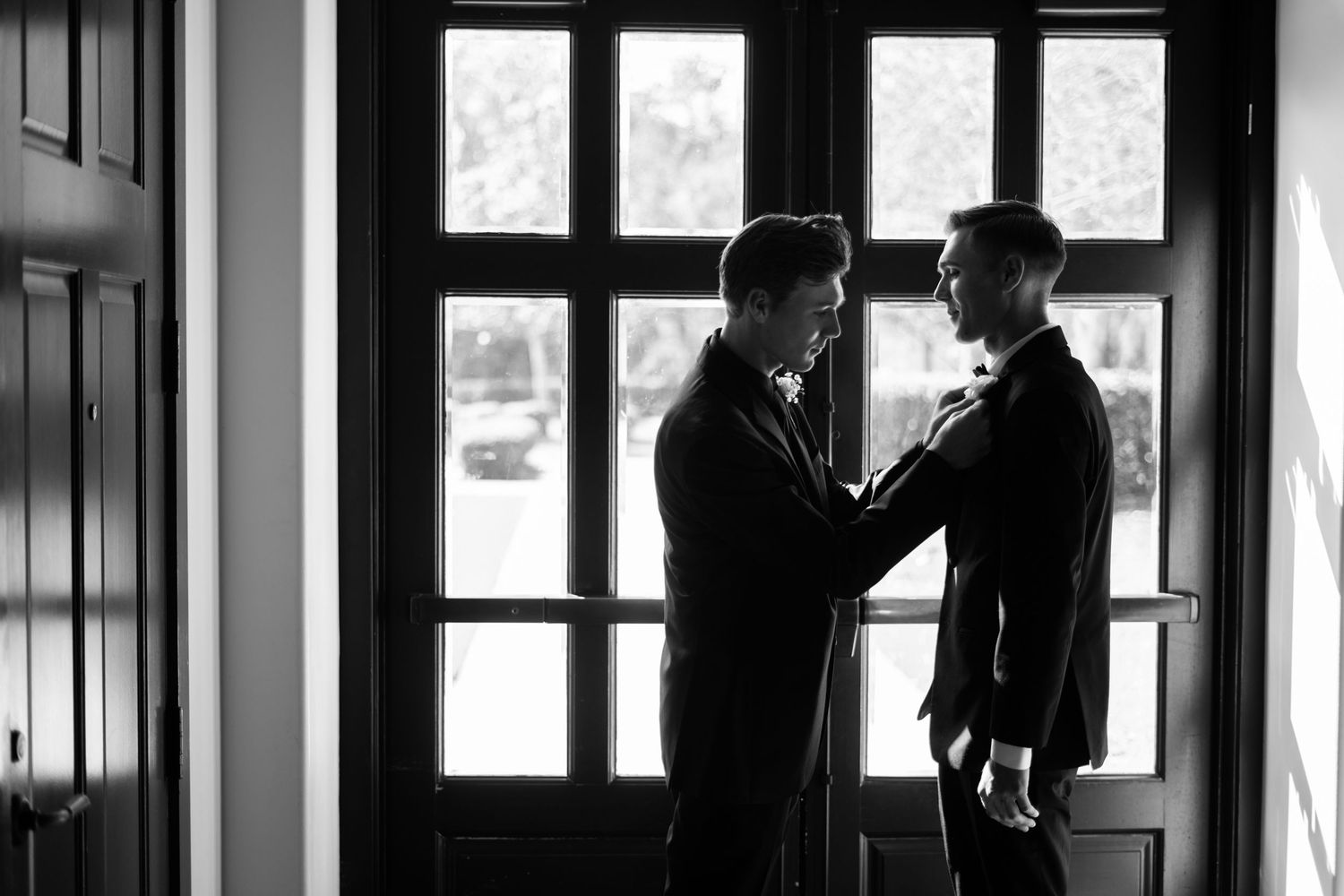 Groom getting ready with groomsman black and white Bella Collina wedding Weddings by Ray