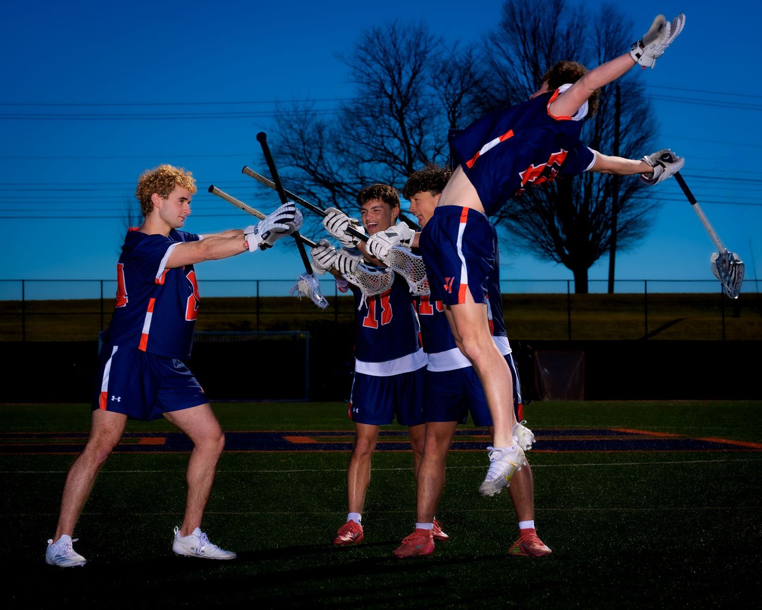 Hershey Trojans boys lacrosse players in a dramatic 2026 class photo, by Deanna Fox, SportsFox Photography based in Hershey PA
