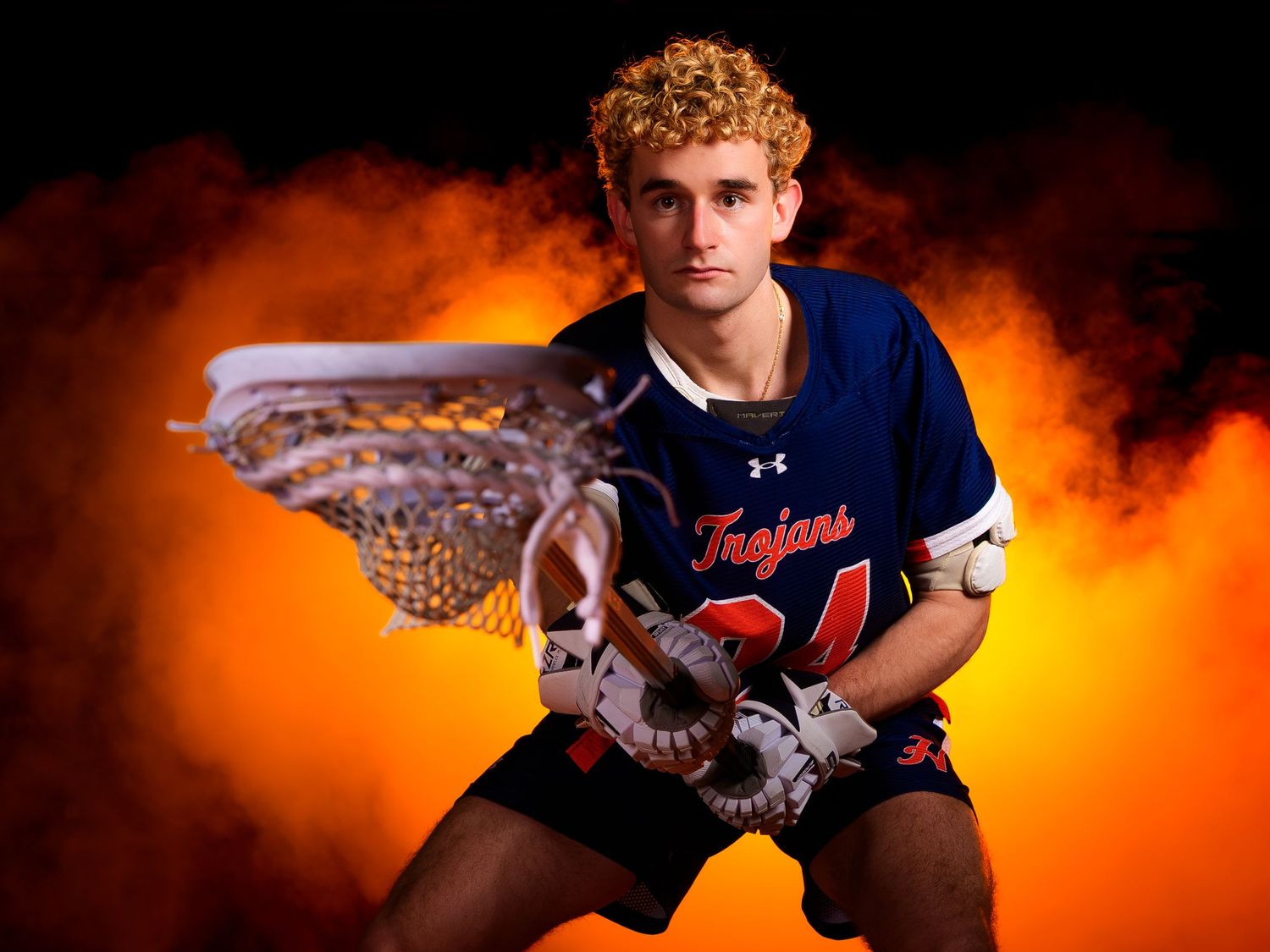 Hershey lacrosse senior 2026 portrait with orange smoke, by Deanna Fox, SportsFox Photography based in Hershey PA