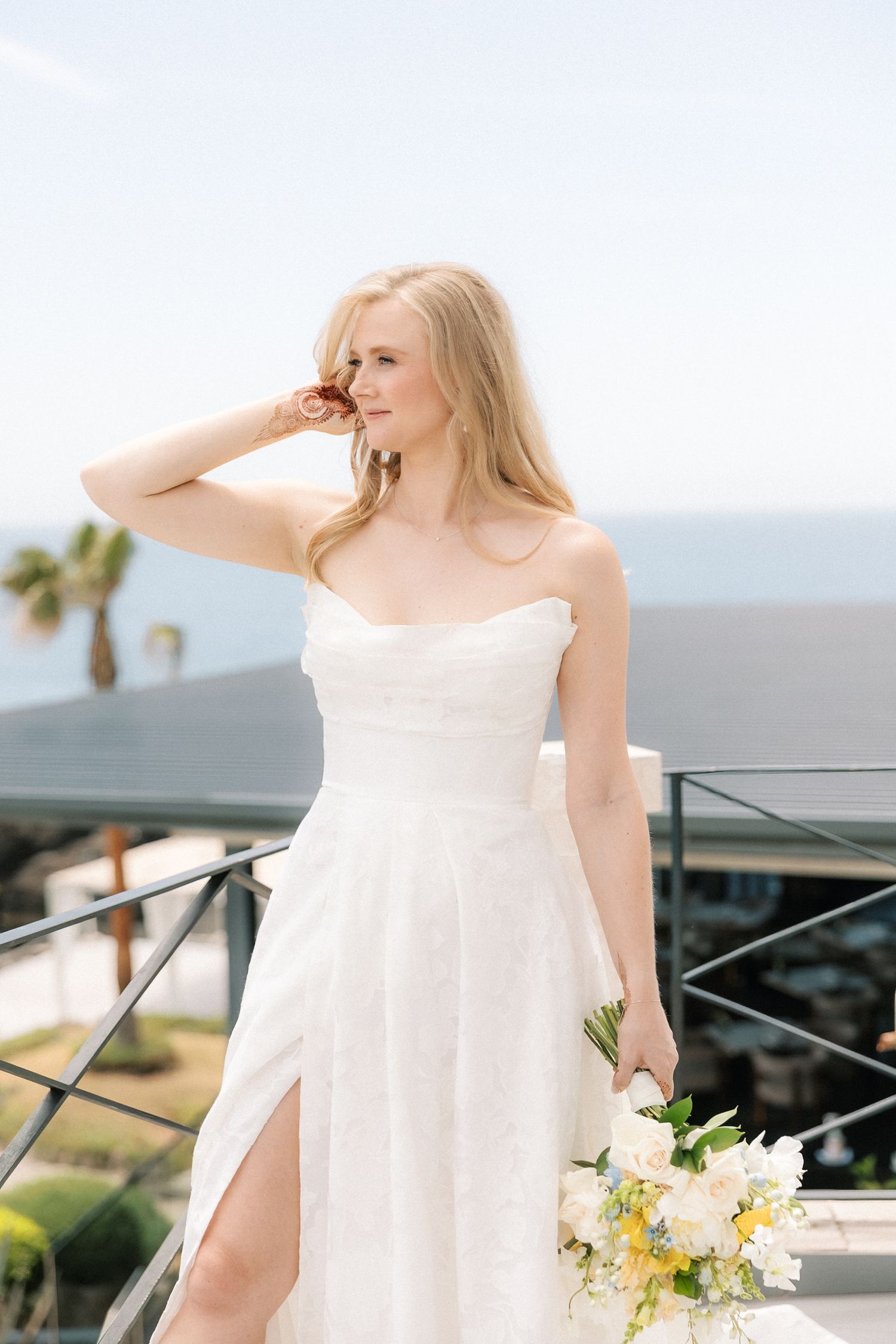 Bride portraits overlooking the Atlantic Ocean  with henna on her hand before her destination wedding ceremony in Cascais, Portugal.