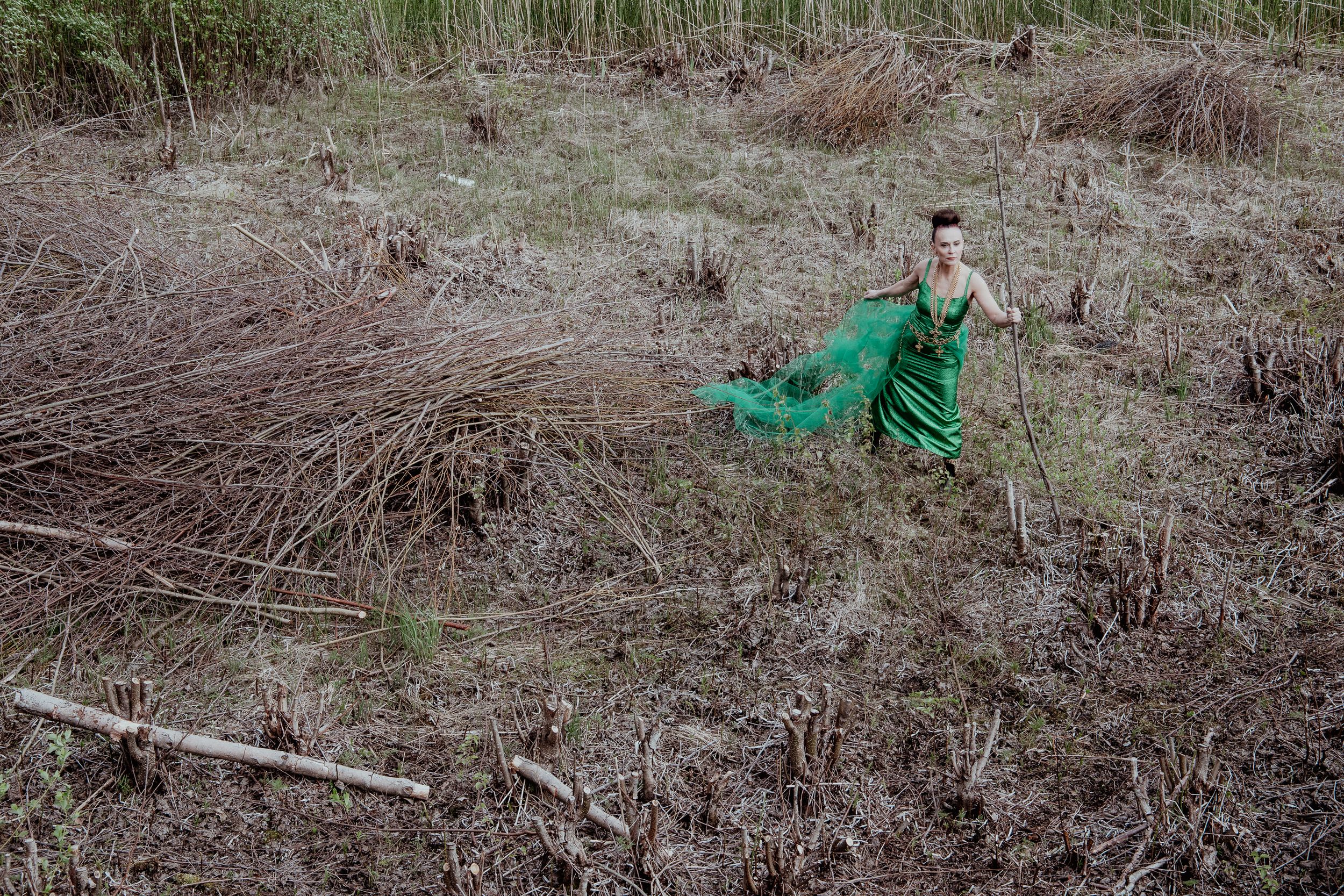 Woman in green dress in an open field
