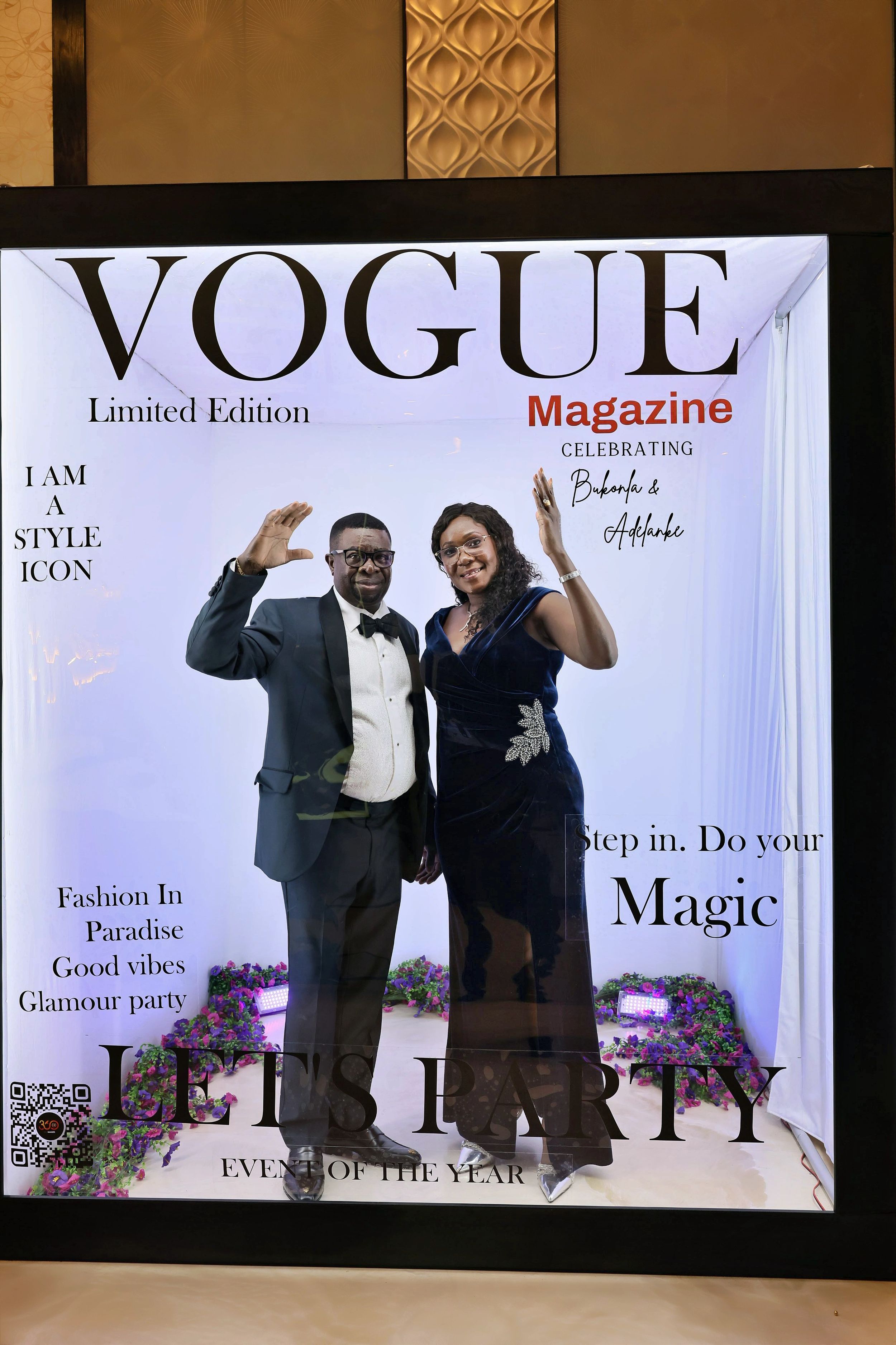 Couple waving at Vogue Magazine Limited Edition Lets Party event photo booth.