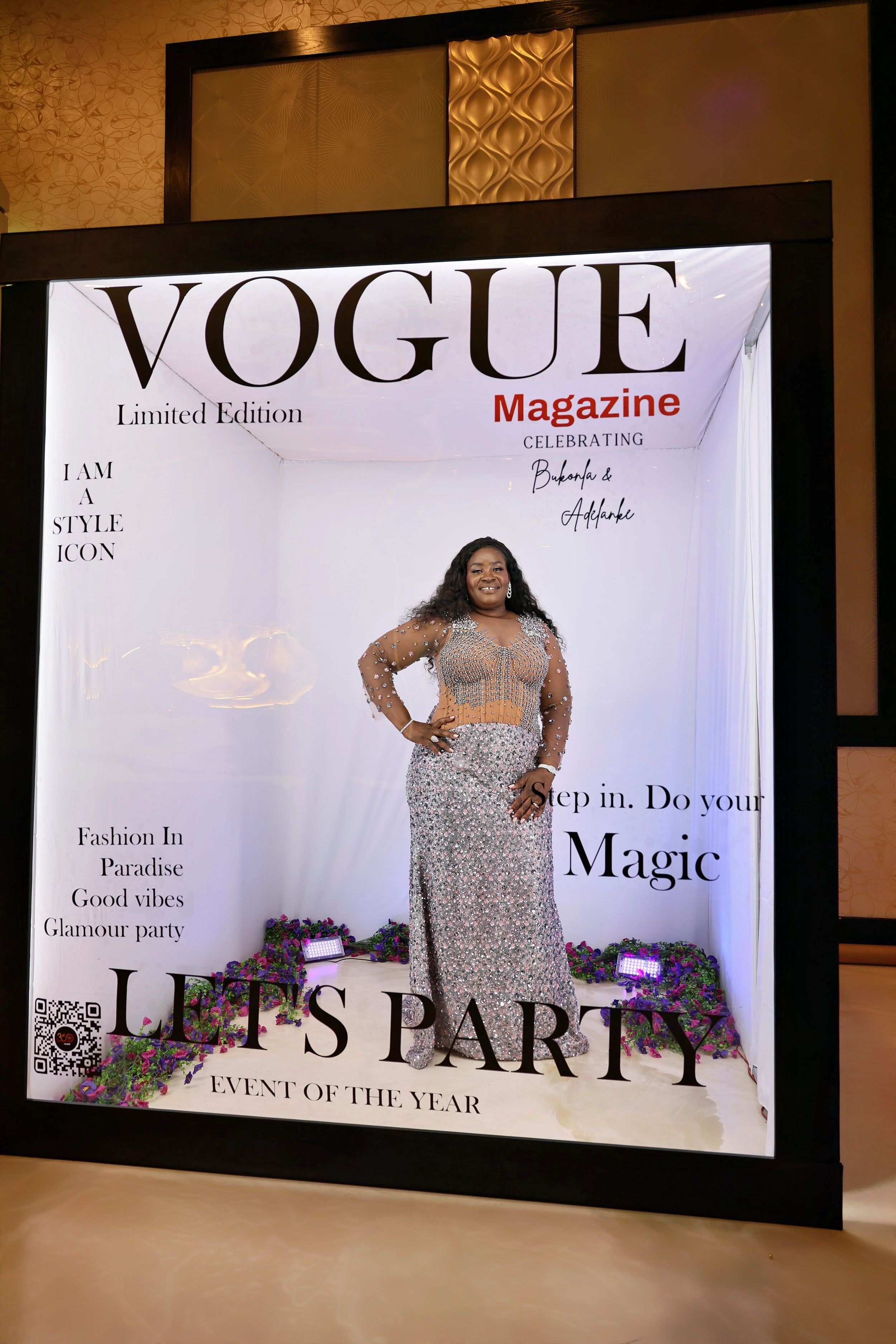 Woman in silver sequin outfit posing at Vogue Magazine Lets Party photo booth.
