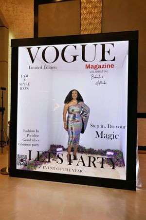 Woman in iridescent sequin dress at Vogue Magazine Lets Party event photo booth.