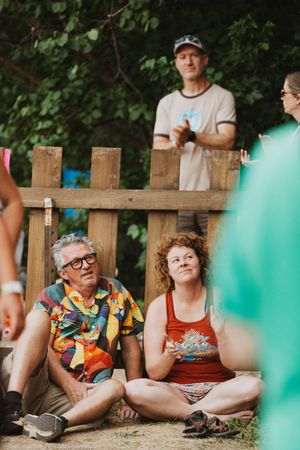 Festival crowd enjoying live music at golden hour in the Colorado mountains.