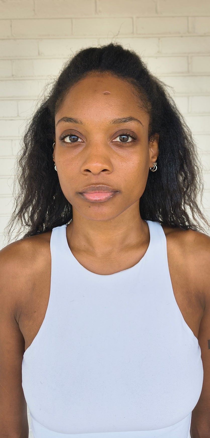Front headshot digital of Genesis Dudley with natural hair and no makeup.