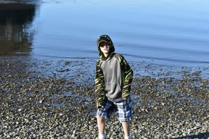 Person standing by the water during a relaxed outdoor lifestyle portrait session