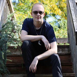 Man sitting on outdoor steps during a relaxed and natural lifestyle portrait session