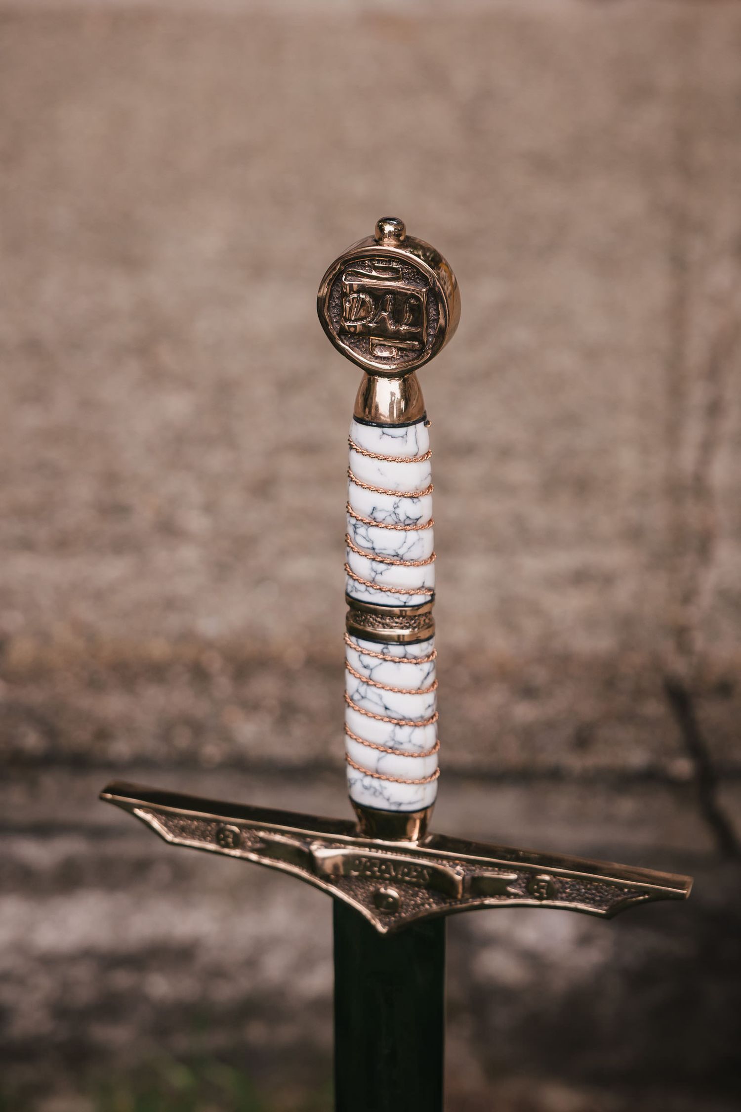 Close-up of an ornamental sword hilt with engraved detailing, part of the ceremony decor at Searles Castle.
