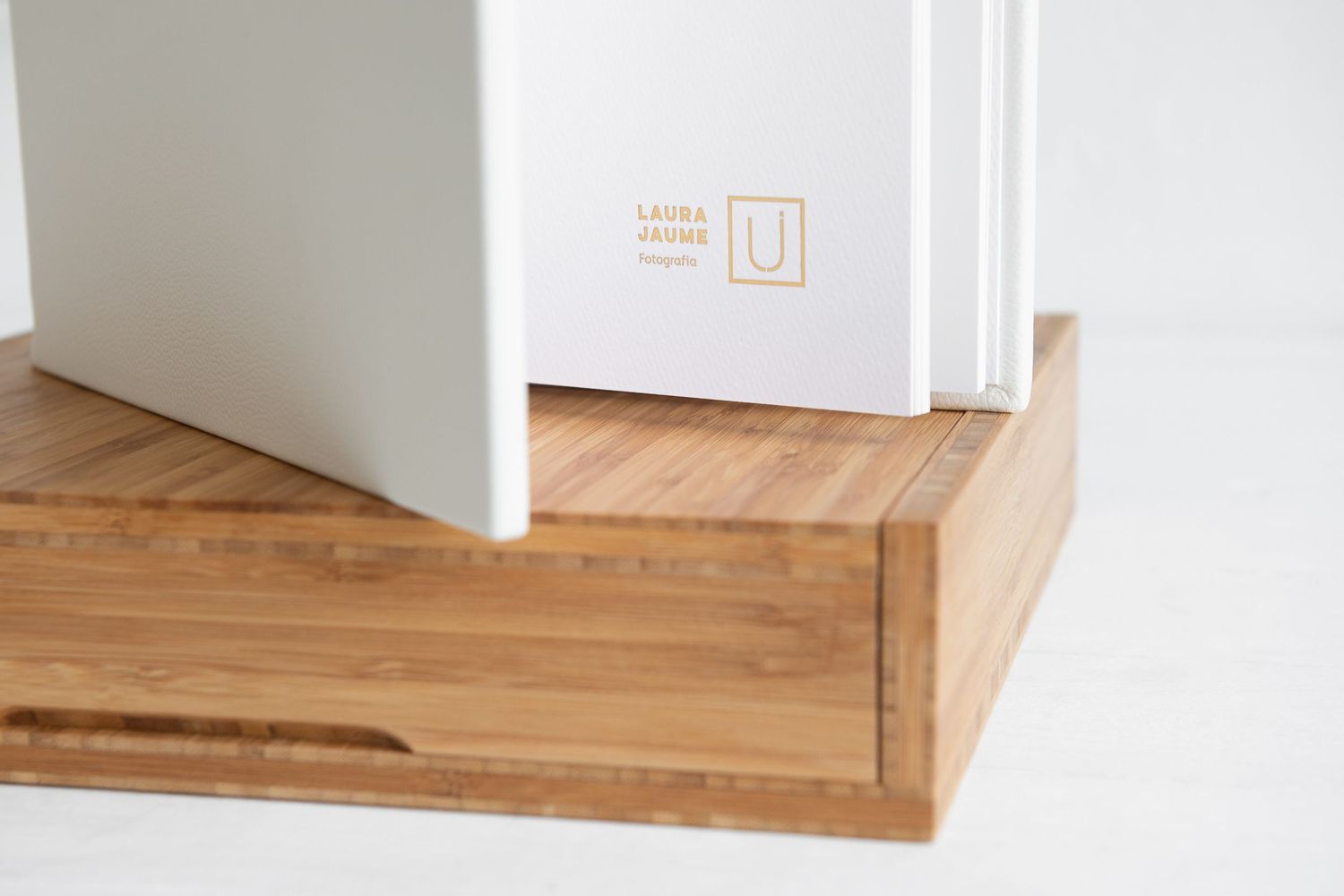 Close-up of wooden shelf corner detail with minimal text on white wall.