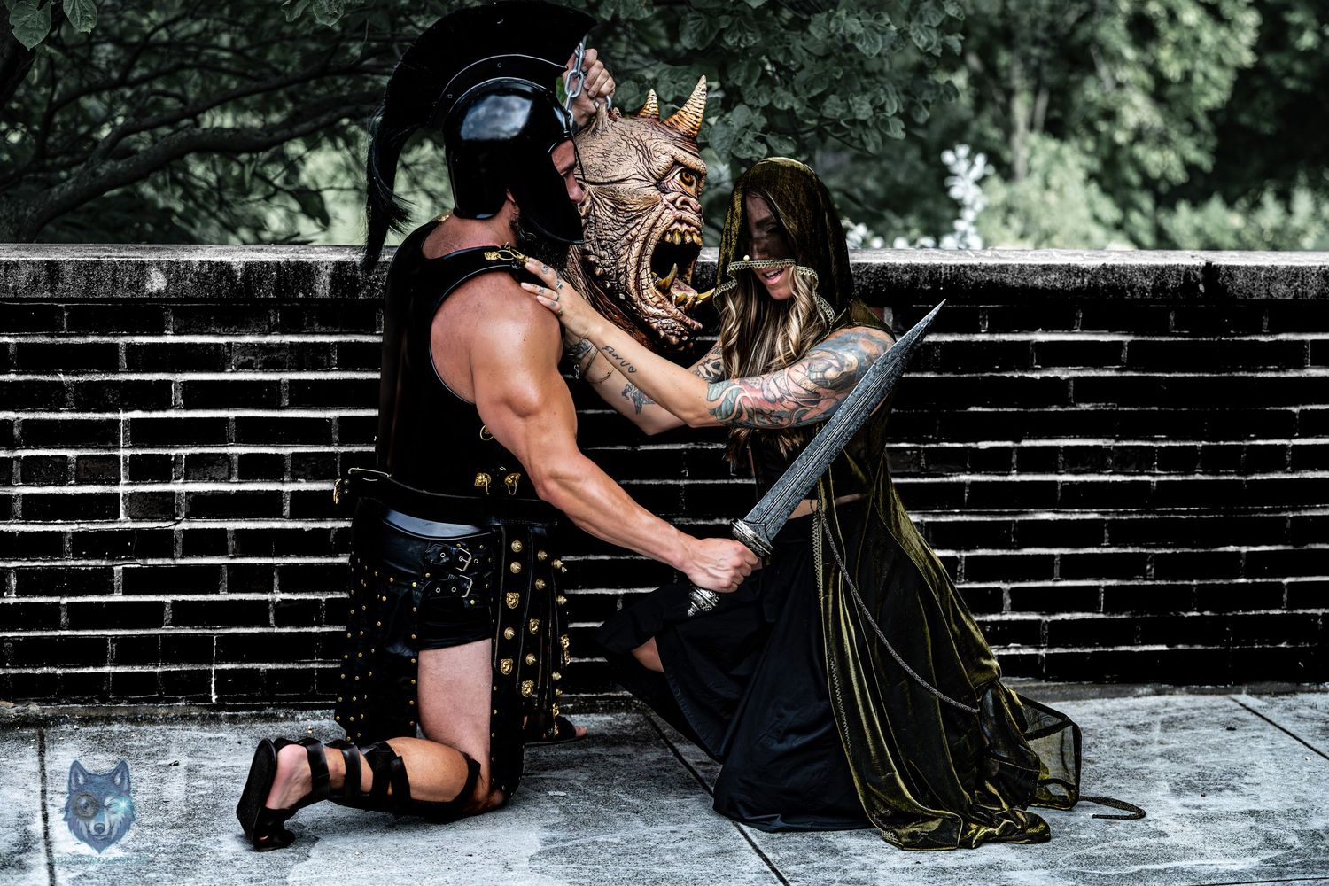 Fantasy cosplay scene with armored gladiator and tattooed woman in gold black cloak. Chi.Shooters meet tonybrettman tattoo_jessie
