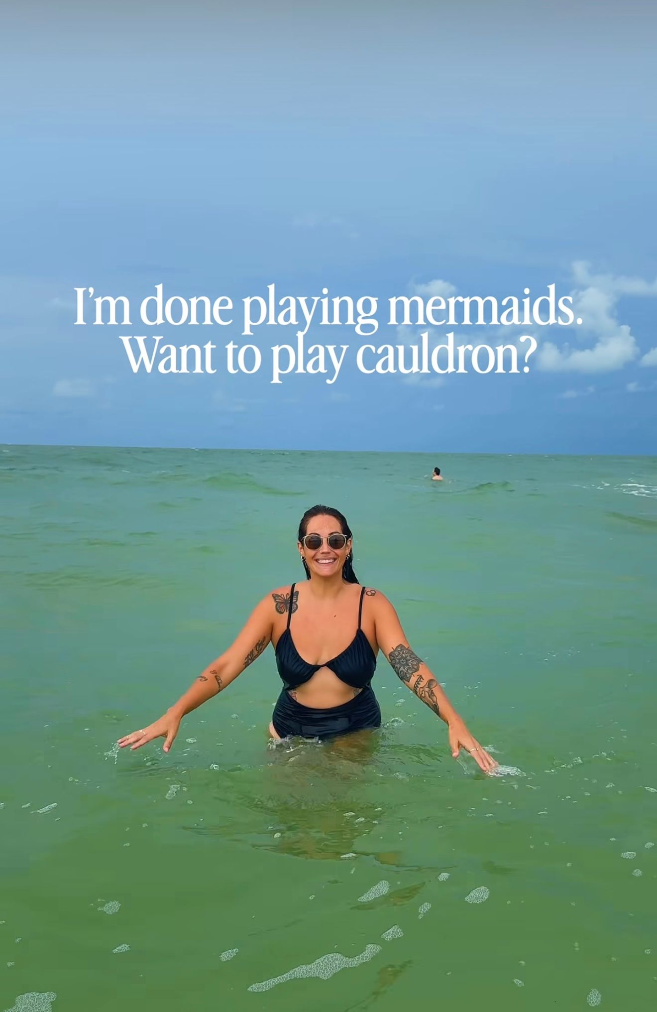 Woman in black bikini standing in turquoise ocean water with text overlay about mermaids and cauldrons.
