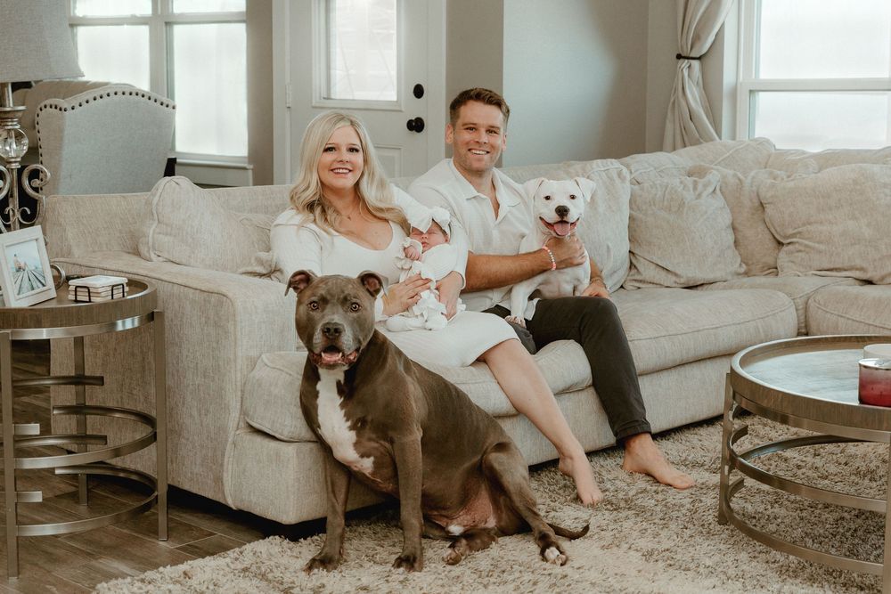 Family portrait with pets in the comfort of your own home during in home lifestyle newborn  session with Tyler Tx motherhood photographer