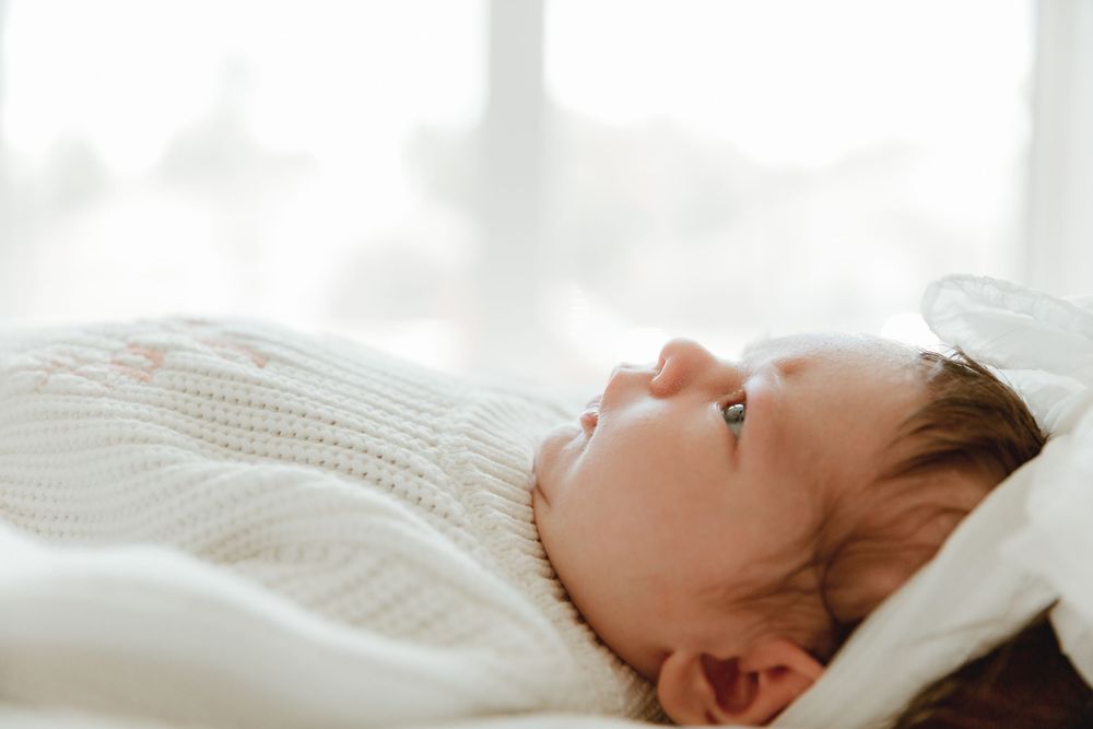 Profile shot of newborn during in--home lifestyle session with Tyler Tx Newborn Motherhood photographer