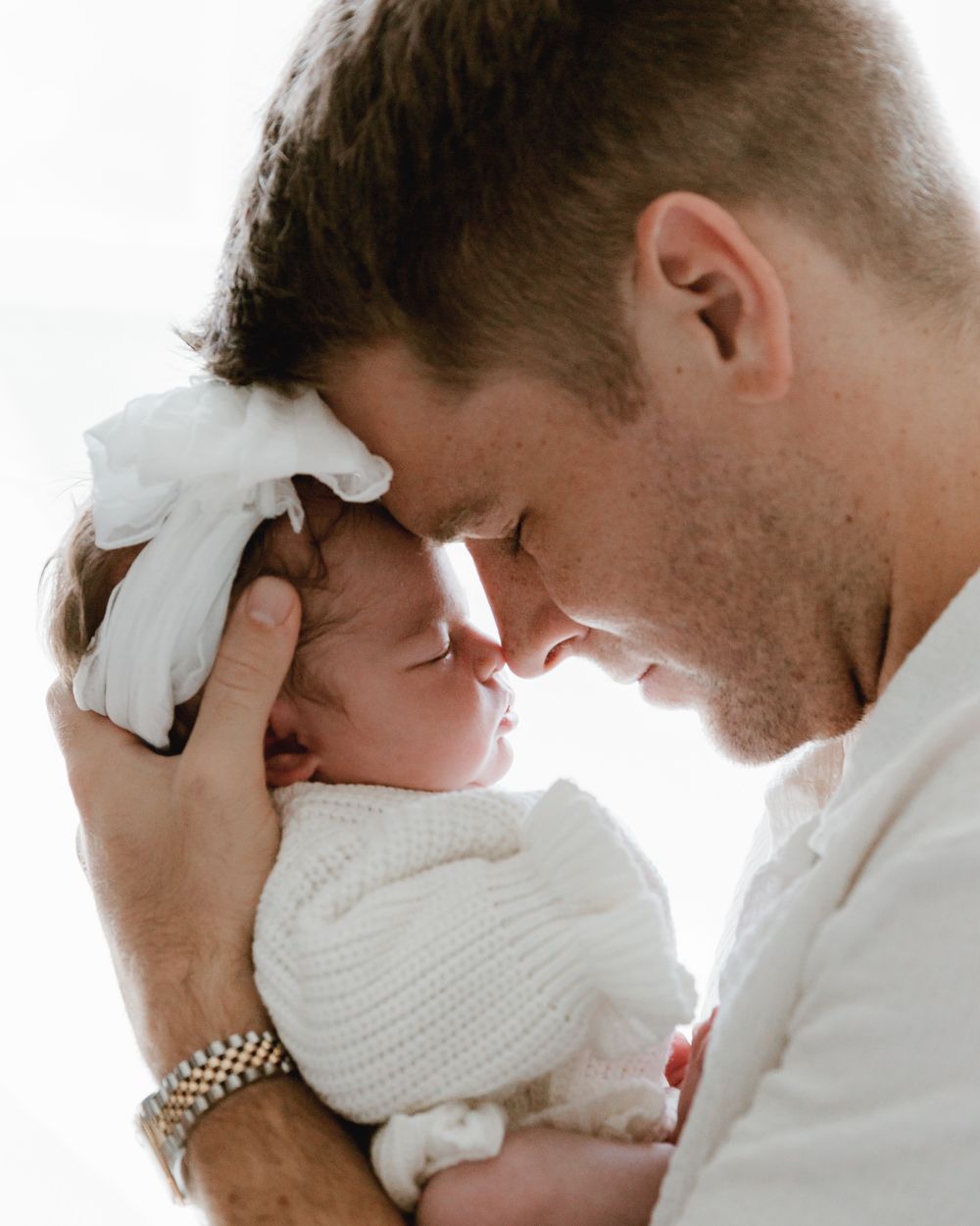 intimate newborn images dad with baby nose to nose during in home lifestyle session with East tx newborn photographer