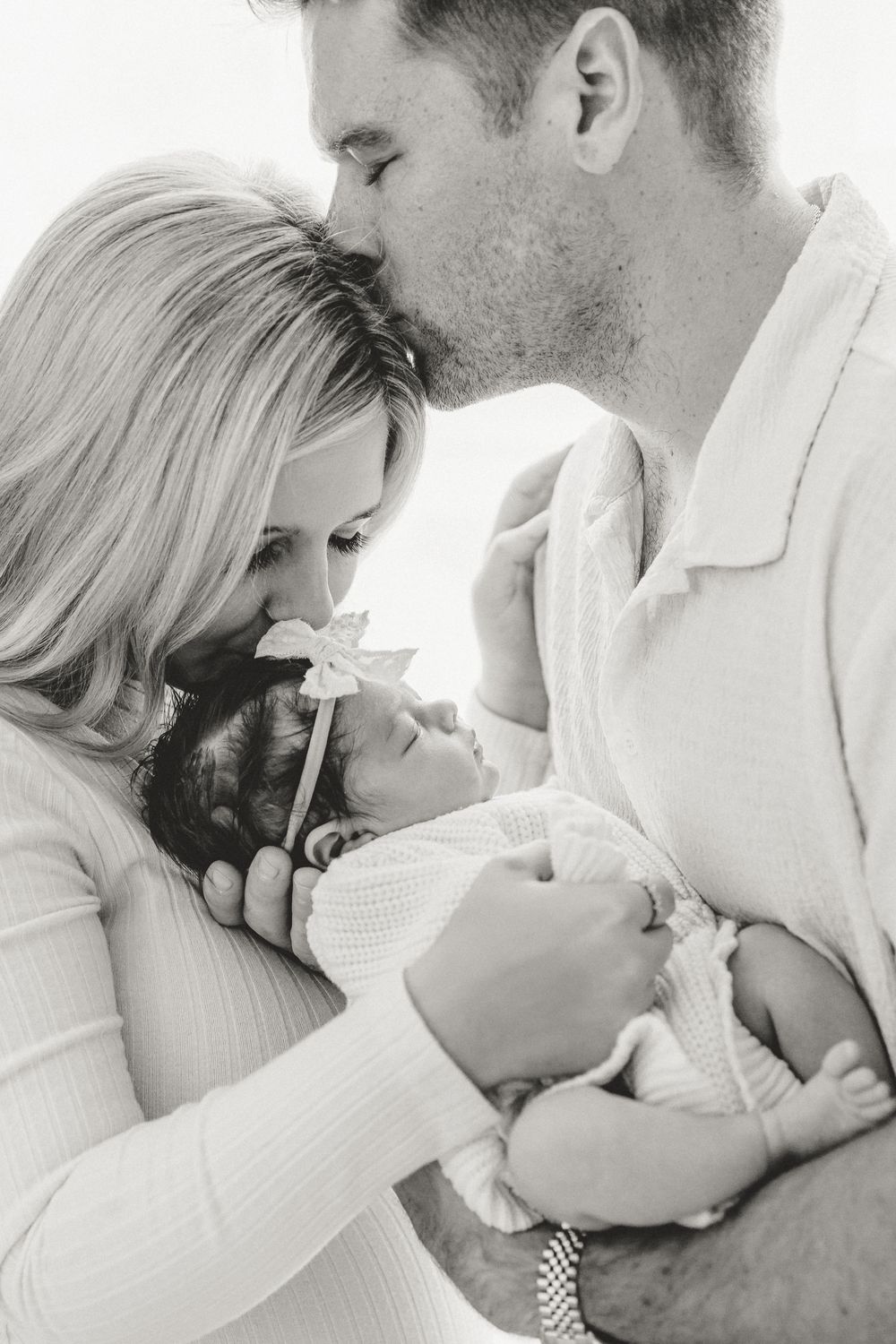 Black and white silhouette image of parents with baby during in-home newborn lifestyle session with East Tx newborn photographer