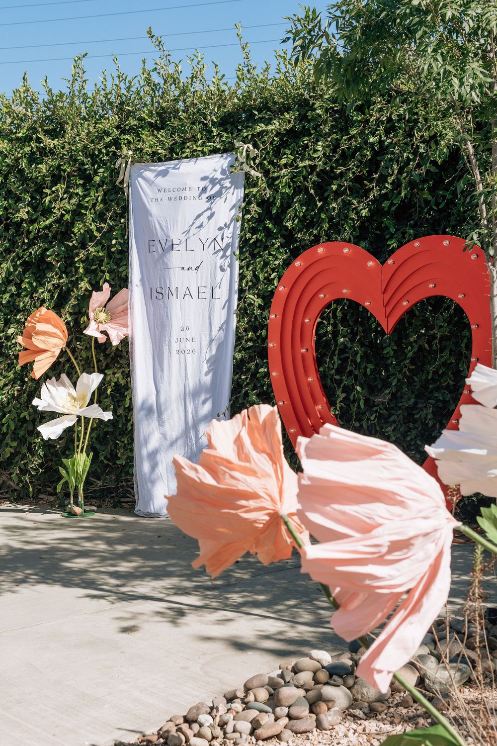 Backyard wedding featuring paper flowers and signs shot on film