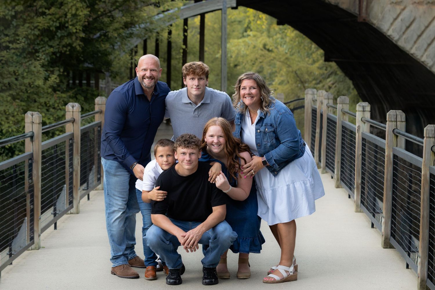Family portrait on boardwalk at Mill Creek Park in Dexter, MI by Brighton, MI photographer
