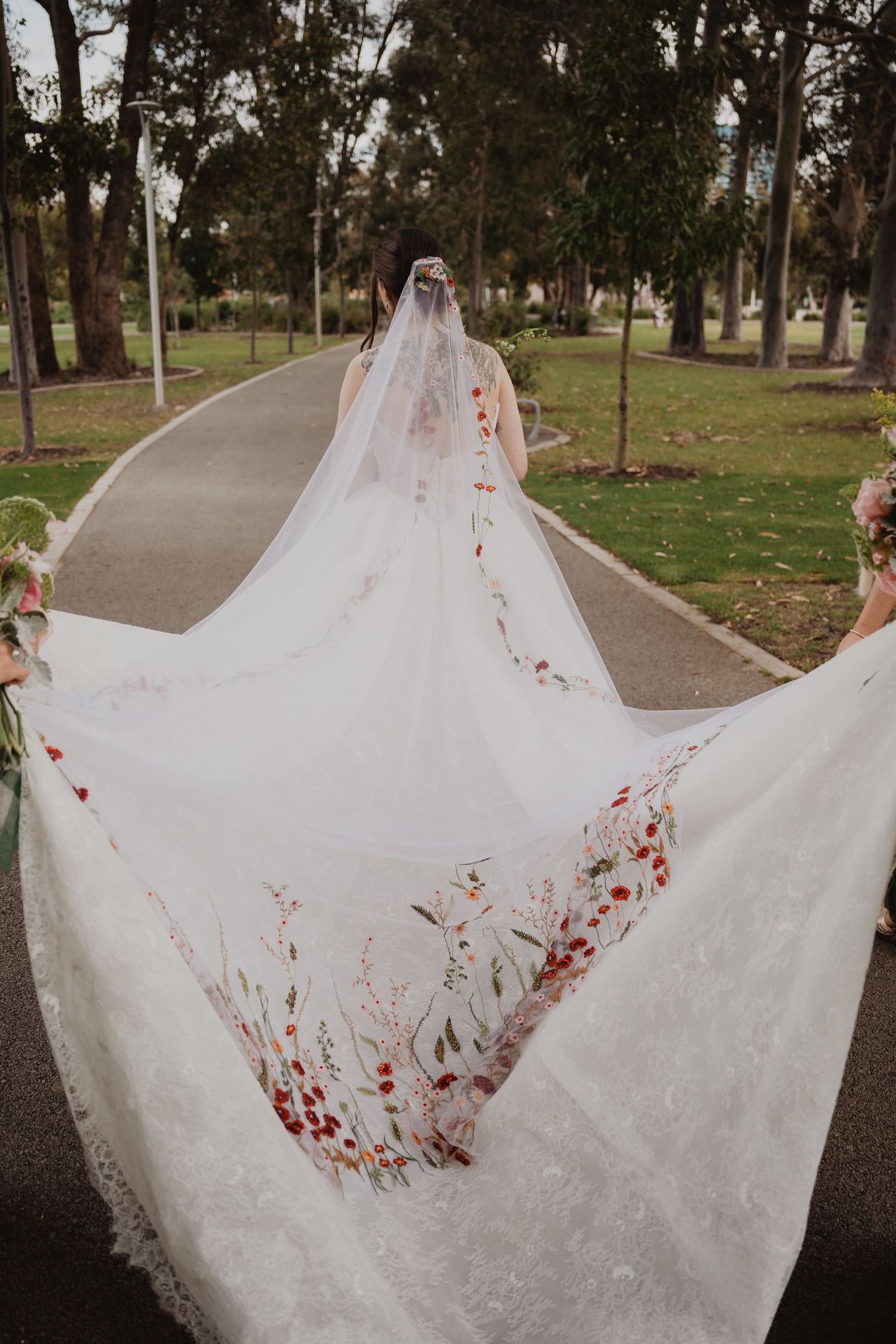 Ella's long veil spread across the grass