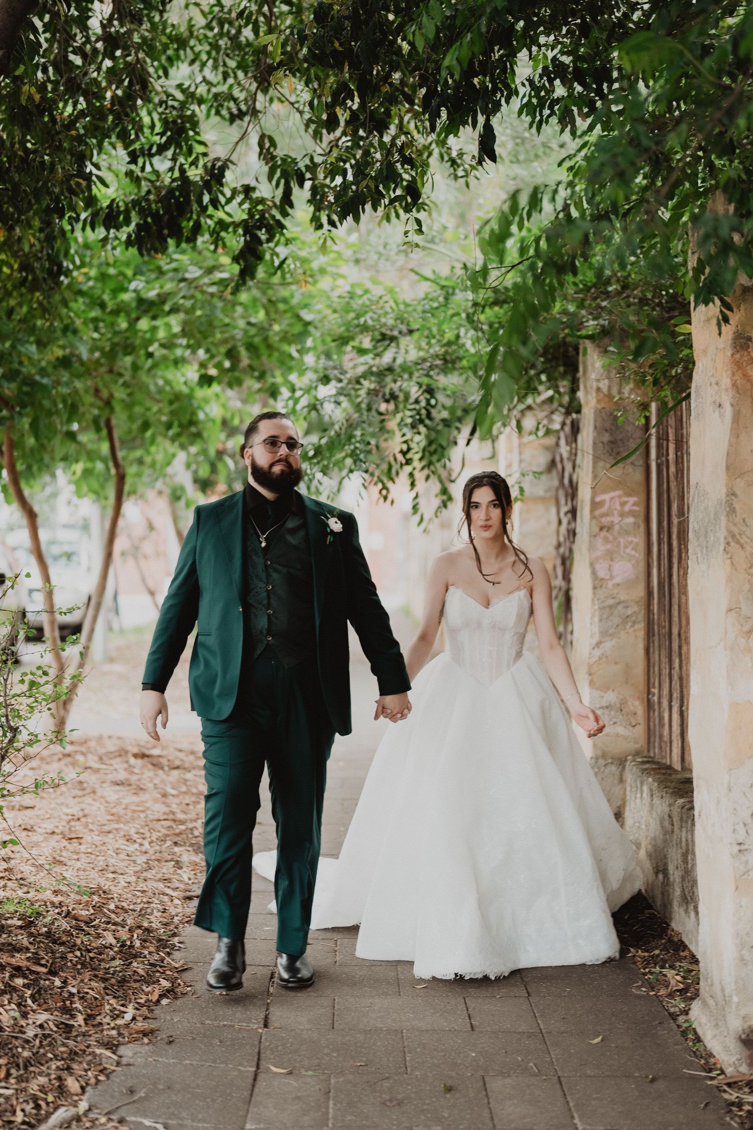Harrison and Ella walking together along a garden path