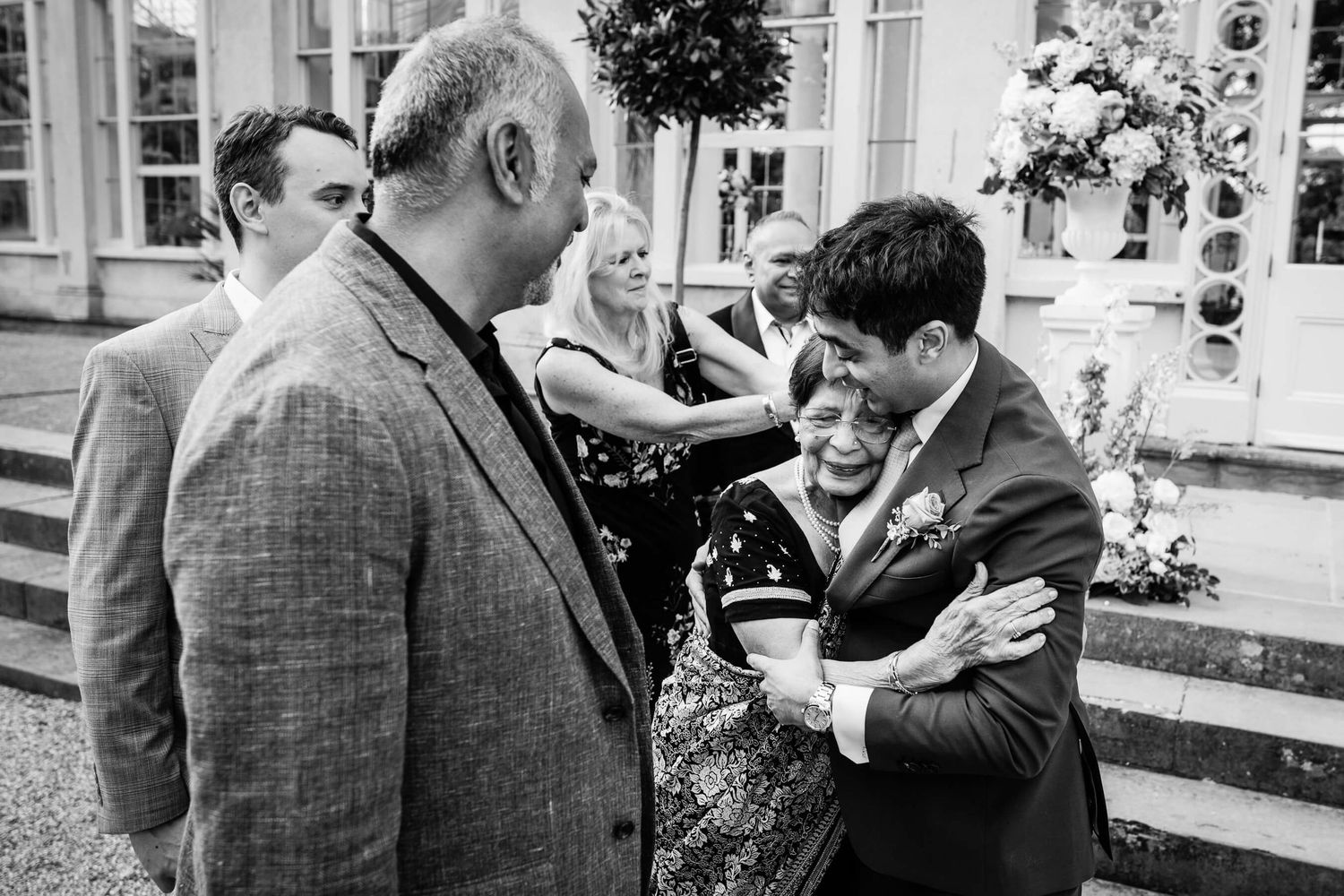 Candid wedding Photography Syon Park. The groom hugging his nan.
