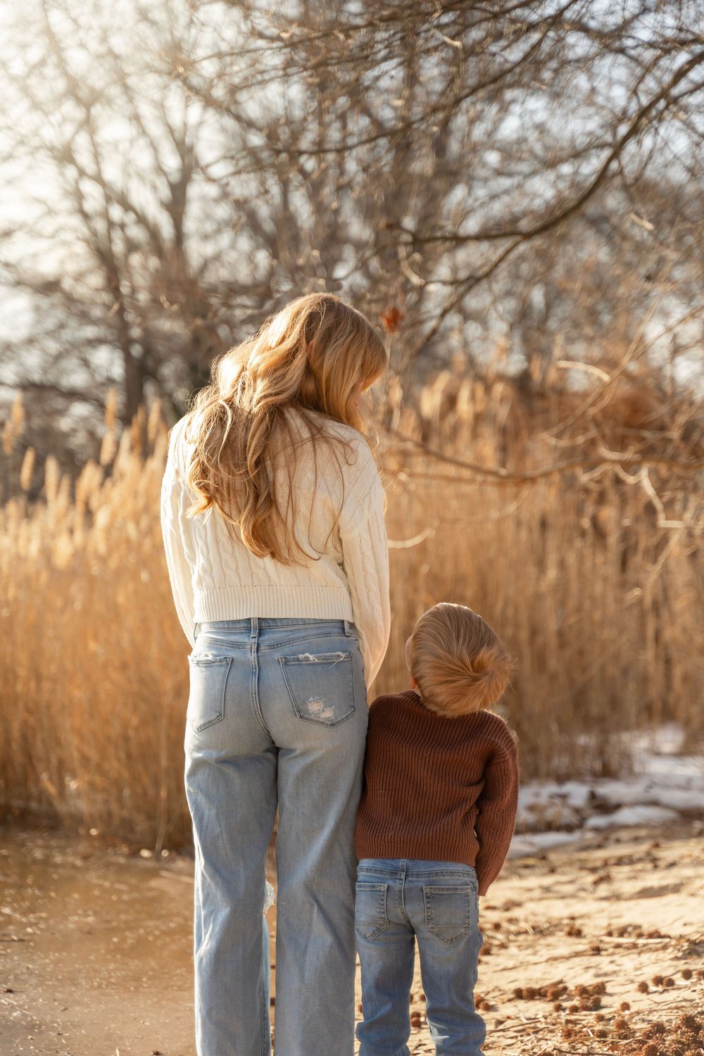 Mother and son looking at each other while facing away from the camera