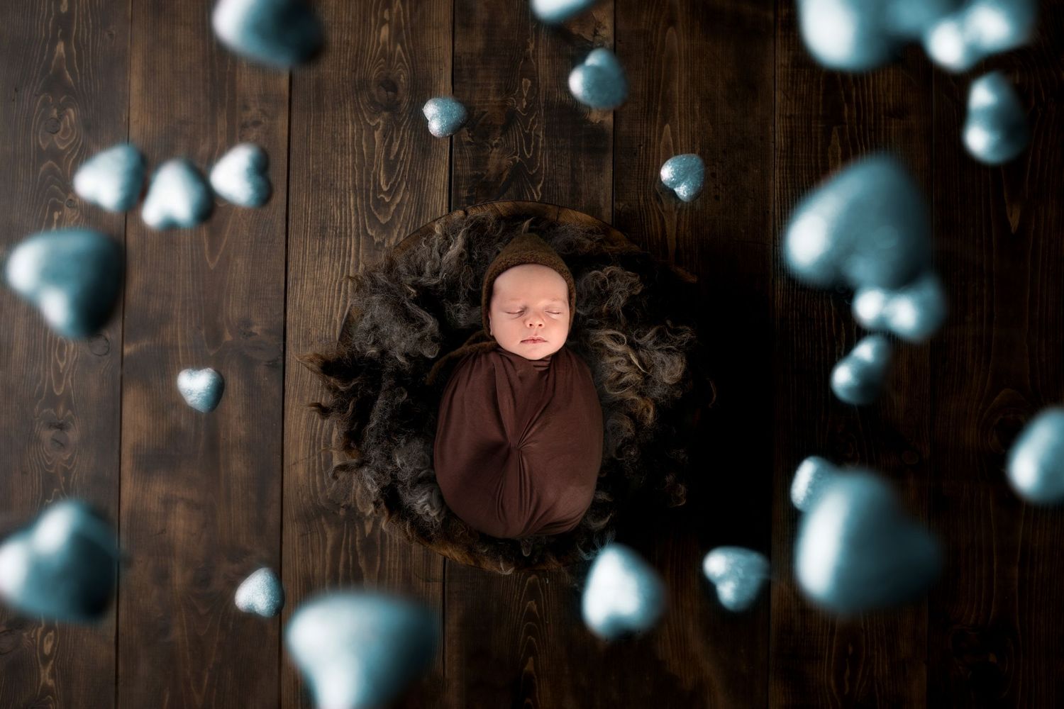 newborn boy in a brown wrap in Gold Coast newborn studio session