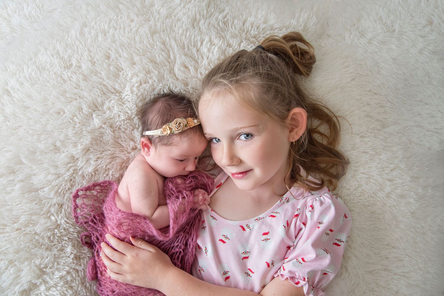 newborn baby girl with her sister in studio at Maylea Sandhu Photography