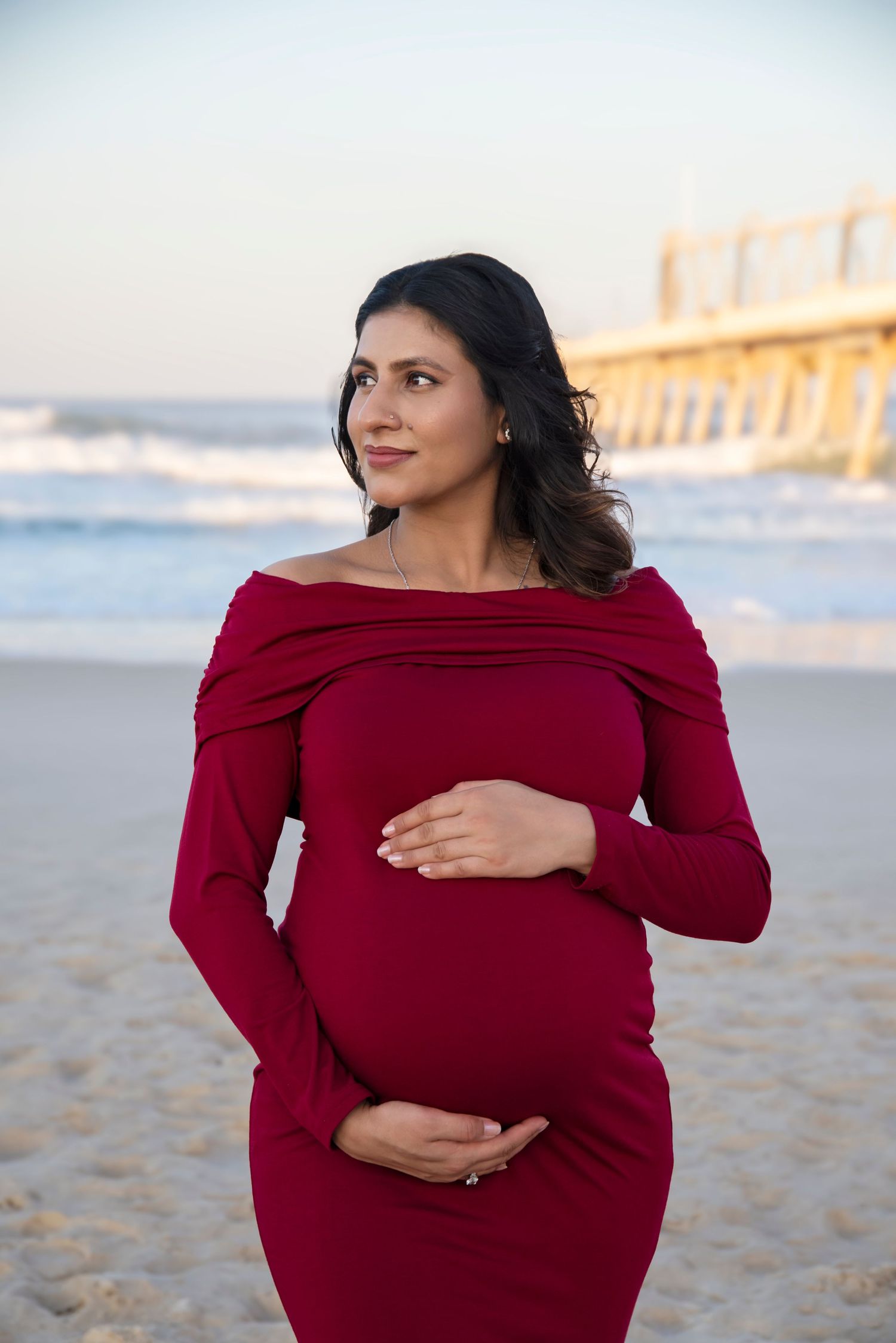stunning mother in red dress for her maternity photography session on the Gold Coast