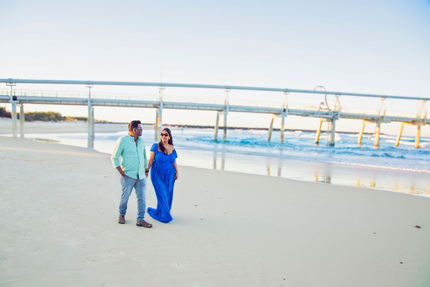 beautiful couple at the spit for their maternity photo session